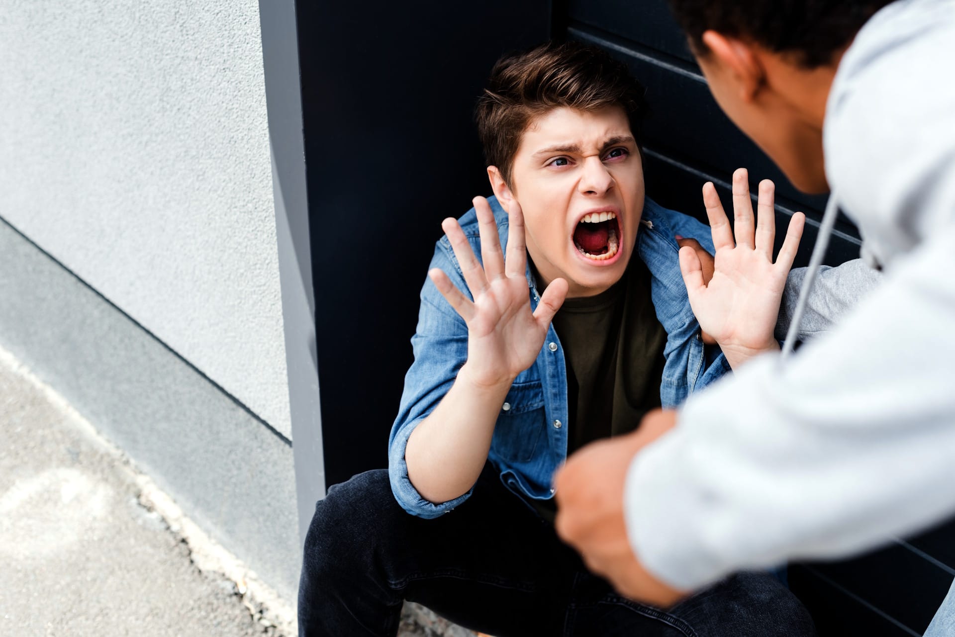 selective focus of american boy punching scared and yelling boy john FRANCEY