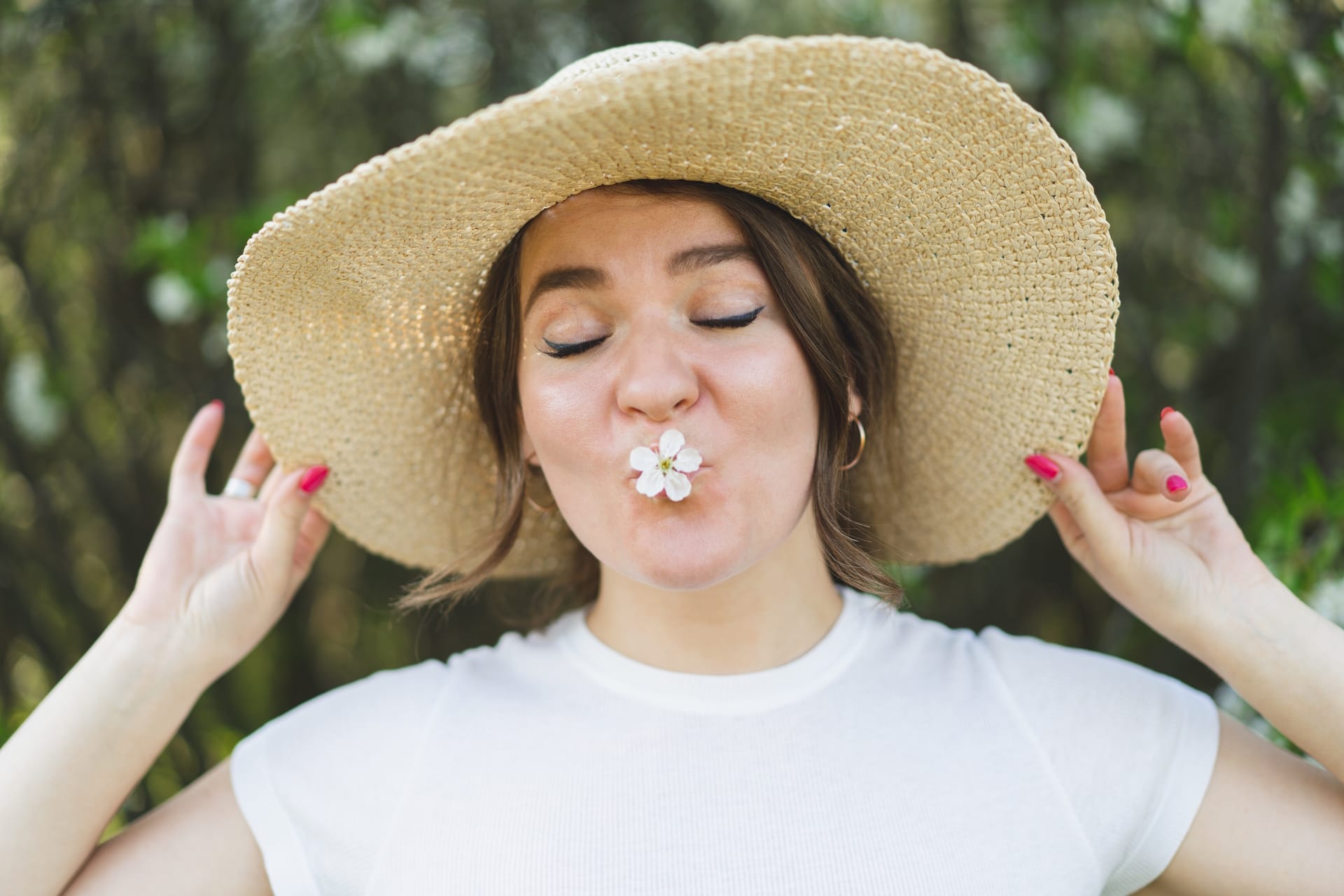 young-funny-beautiful-woman-in-a-hat-among-flower-John-FRANCEY